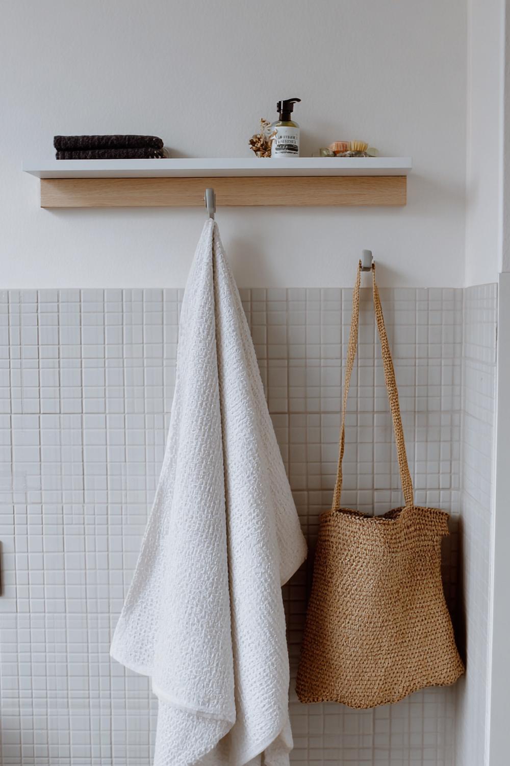 9. Badezimmer Deko Ideen klein: Minimalistische Bilderleiste über dem Handtuchhaken