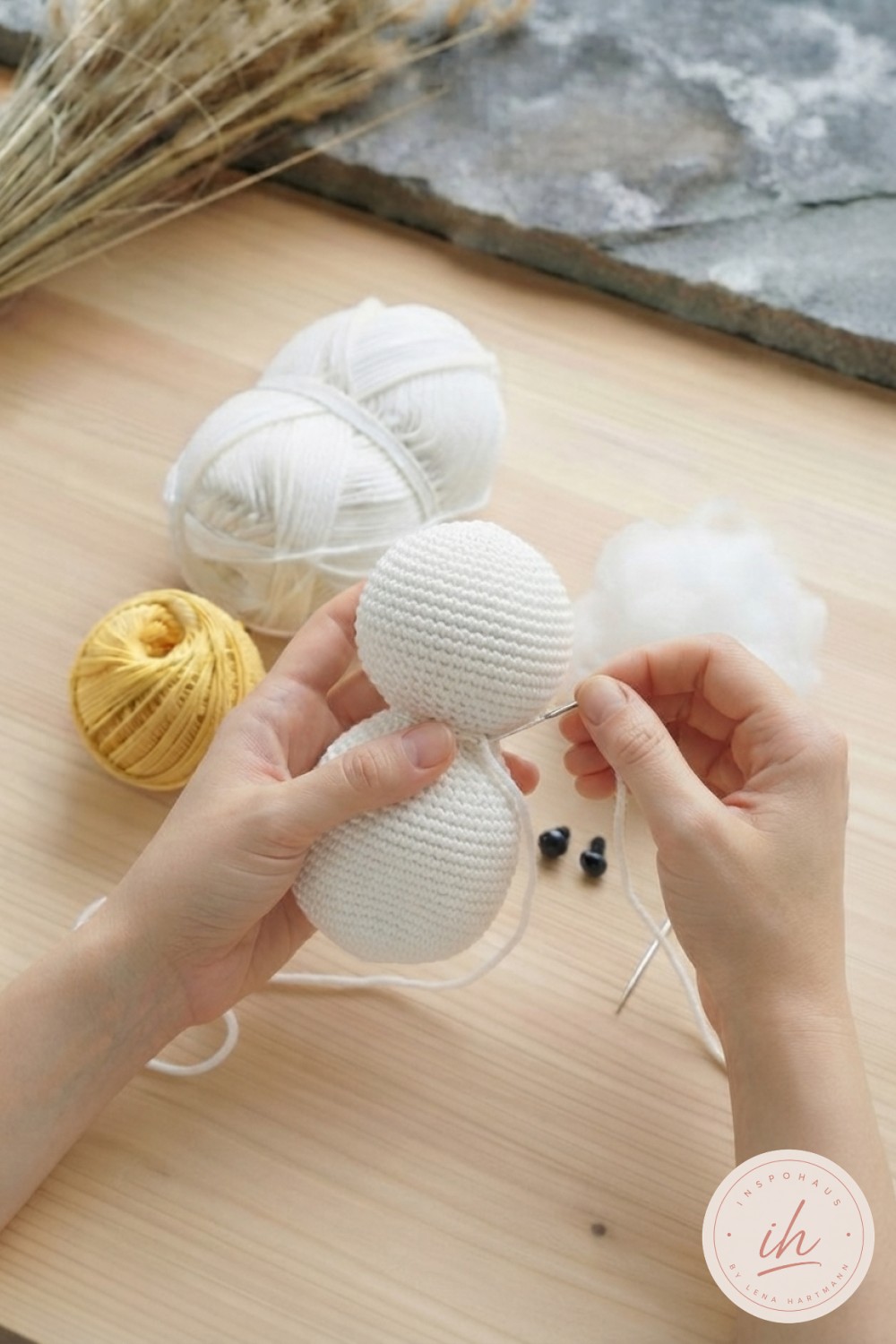 Kopf wird an den gestopften Körper genäht, klassischer Moment beim weiße Ente Amigurumi häkeln mit Wollnadel