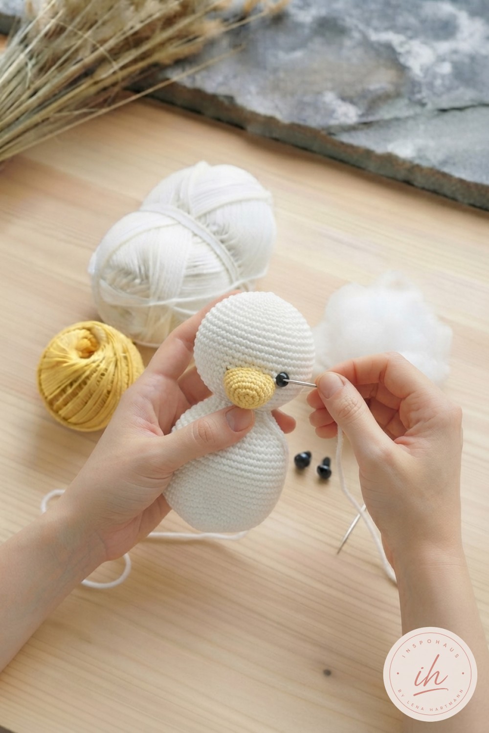 Schwarze Sicherheitsaugen und gelber Schnabel entstehen, Gesicht nimmt beim weiße Ente Amigurumi häkeln Form an